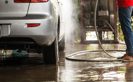 Worker washing car in the carwashの写真素材