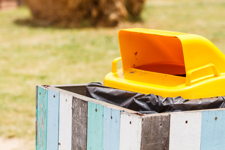 Outdoor yellow recycle bin in the parkの写真素材