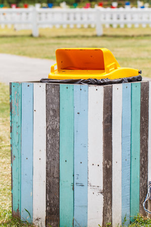 Outdoor yellow recycle bin in the parkの写真素材