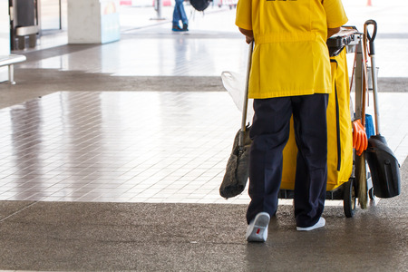 Woman cleaner with Mop bucket in office buildingの写真素材