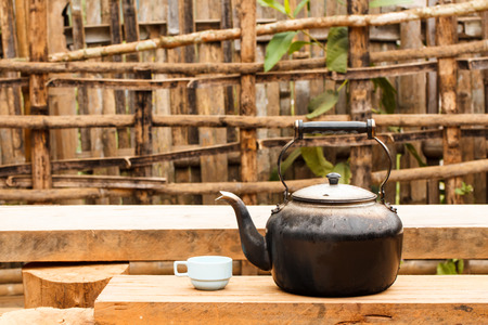 Old tea kettle with glass outdoorの写真素材