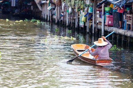 People with small boat in the float market, Thailandの写真素材