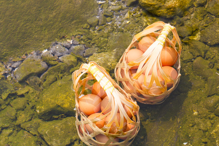 Two basket of boiled eggs in hot spring at Jaeson National Park in Lampang, Thailandの写真素材