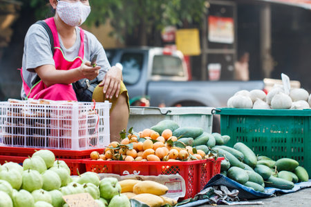 Fruits at local market with seller backgroundのeditorial素材