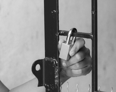 Concept of hand and key in the red borderの写真素材