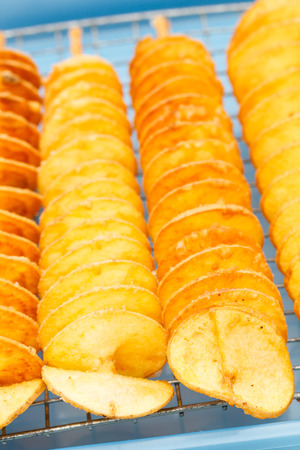 Fired spiral sweet potato at local market, Thailandの写真素材