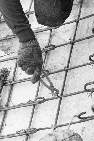 Construction worker with hand work in the cement formwork framesの写真素材