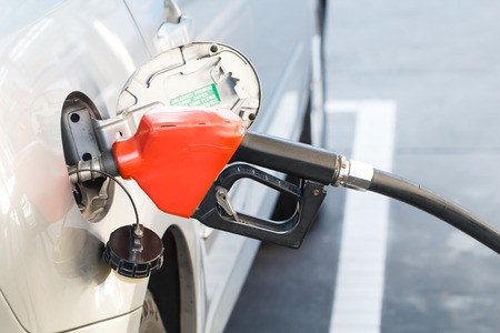 Red pumping fuel oil in car at gas station-3の写真素材