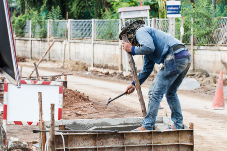 Rural construction worker working on roadの写真素材