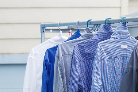 Blue shirt wait for dry during daytimeの写真素材