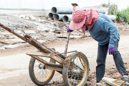 Rural woman worker working on road constructionの写真素材