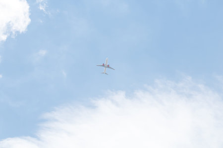 airplane cruising with the clouds and blue sky
