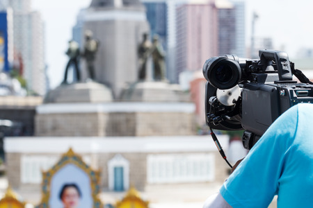 High Definition TV camera with man working outdoorの写真素材