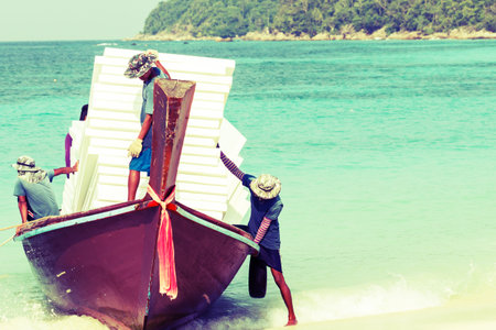 Workers shipping foam with small boat to the beach at koh Lipe Satun, thailand.のeditorial素材