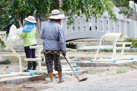 Women construction worker working in public parkの写真素材