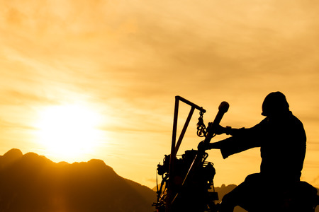 silhouette fisherman and beautiful sunset in thailandの写真素材