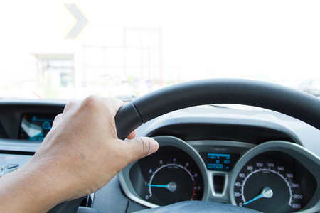 Close-up of man hand holding steering wheel-2の写真素材