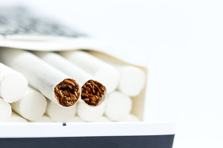 White cigarettes in pack on white backgroundの写真素材