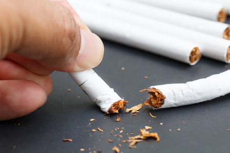 Quit smoking concept of hand crushing cigaretteの写真素材