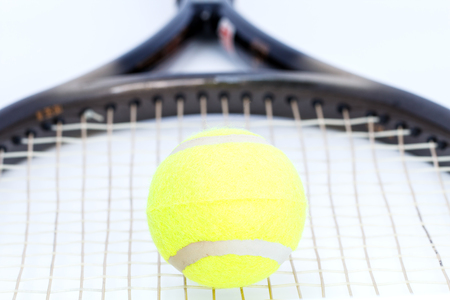 Tennis ball with racket on white backgroundの写真素材
