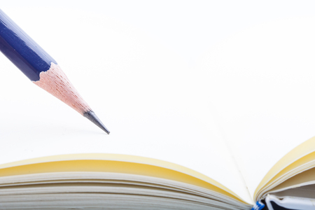 Open book with blue pencil as paper background and textureの写真素材