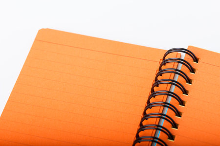 Open orange color notebook with line pages