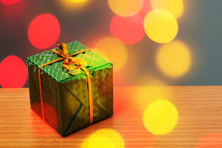 Green bax xmas with red and yellow bokehの写真素材