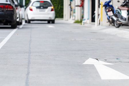 Road sign in car park and car driving backgroundの写真素材