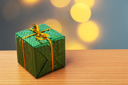 Green chrismas box and yellow bokeh backgroundの写真素材