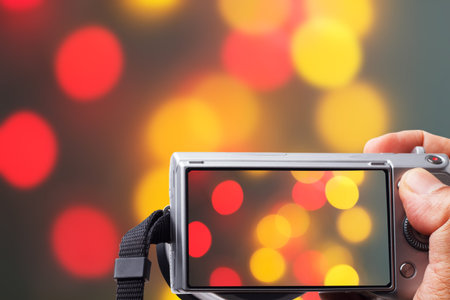 SLR camera in hand view bokeh background