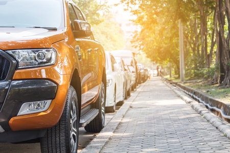 Orange car parking in line outdoor on daytimeの写真素材