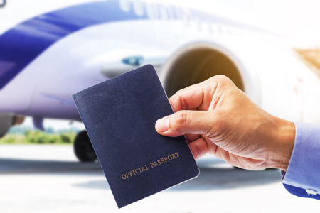Hand with Thailand passport with airplane backgroundの写真素材