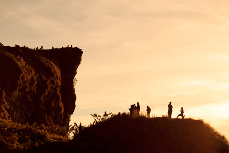 Silhouette of tourist on Phu Chi Fa Forest Park at sunrise time - Chaingrai, Thailandの写真素材