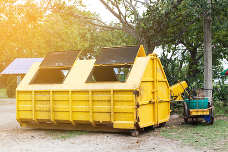 Yellow bin or trash placed outdoorの写真素材