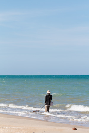 Fisherman working at sea beach on daytimeの写真素材