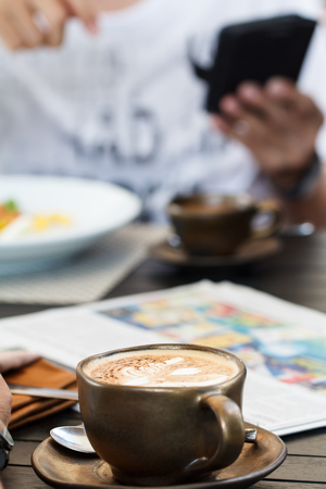 Cup of coffee with newspaper for morning breakfastの写真素材