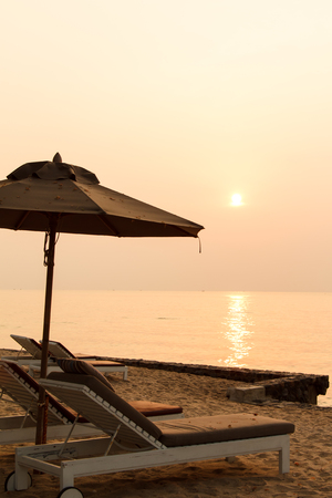 Beach chair and sunset in morningの写真素材