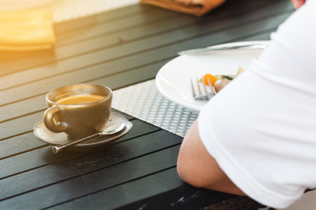 Man eating breakfast and drink coffeeの写真素材