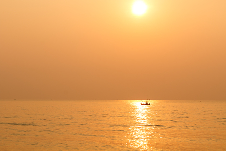 Minimalist of silhouette small boat when sunsetの写真素材