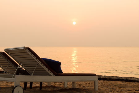 Beach chair and sunset in morningの写真素材