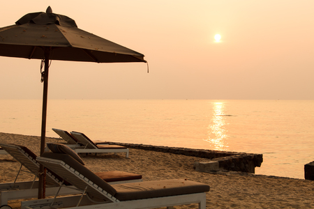 Beach chair and sunset in morningの写真素材