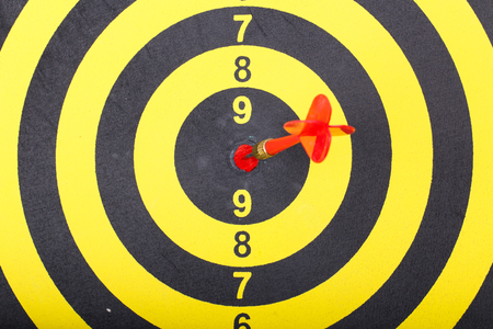 Top view of red arrow in target on yellow dart boardの写真素材