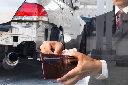 Concept of businessman repair car accident with cashの写真素材