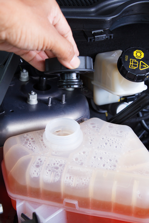 Closeup hand checking water car engineの写真素材