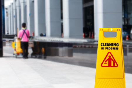 Janitorial mop bucket on cleaning in process and blur worker backgroundの写真素材