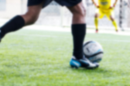 Blurred of soccer ball player action in match competition on green field