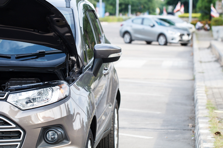 Brown car parking on the side of the road with car in back. For assistance repair by a qualified car mechanic.の写真素材