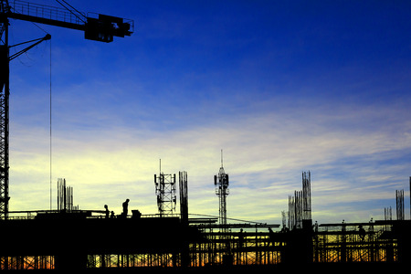 Silhouette images of construction sites are underway and workers are workingの写真素材