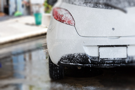 White car washing at the car wash shop to clean up dirt and keep the health of the driver and passengers.の写真素材