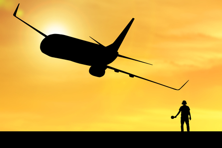 Silhouette of employee working for airplane taking off flight with orange background and sunset in backの写真素材